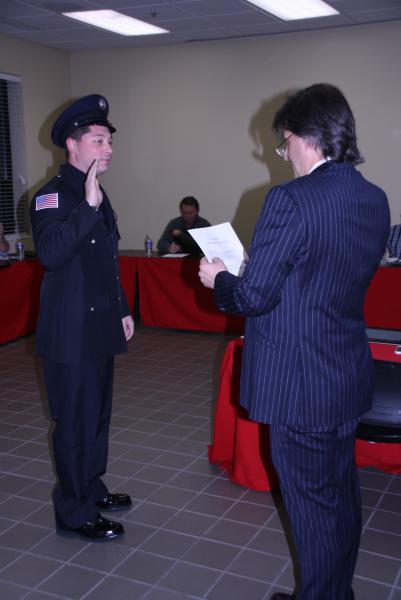 James Janchenko is sworn-in as Firefighter/Paramedic by Trustee Steve Stratakos on December 9, 2014.